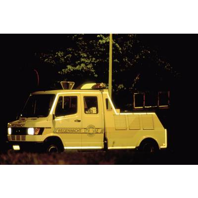 A yellow breakdown vehicle from the "Roadside Assistance" is parked at the roadside at night with its hazard lights on, illuminated by street lamps.