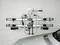 Bicycle carrier mounted on a white wall next to a silver vehicle. The carrier is ready for bicycle attachment.