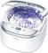 Ultrasonic cleaning device with display showing '3:47'. Open lid reveals illuminated, bubbling water in the container.<br><br>Note: The translation is already in British English, so no further changes are needed.