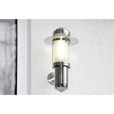 Silver wall light mounted on a white wall, switched on, casting warm light, modern design.