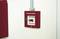 Red fire alarm on the wall; label reads 'Fire Brigade'. Instructions: 'Smash glass, press button firmly'.
