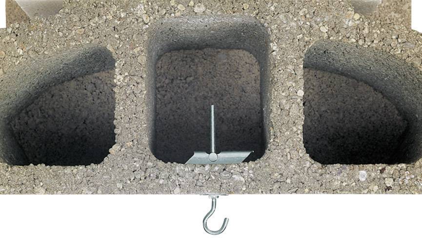 Concrete block with hook and metal fixing in one of the hollow chambers.