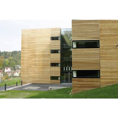 A modern building with wooden cladding and large windows is situated in a green, rural setting with a few houses in the background.