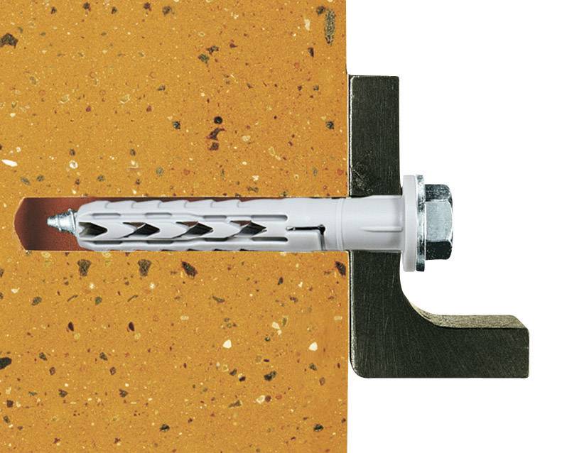 Cross-section of a wall with a grey wall plug holding a metal connection. The wall is in an orange hue with speckles.