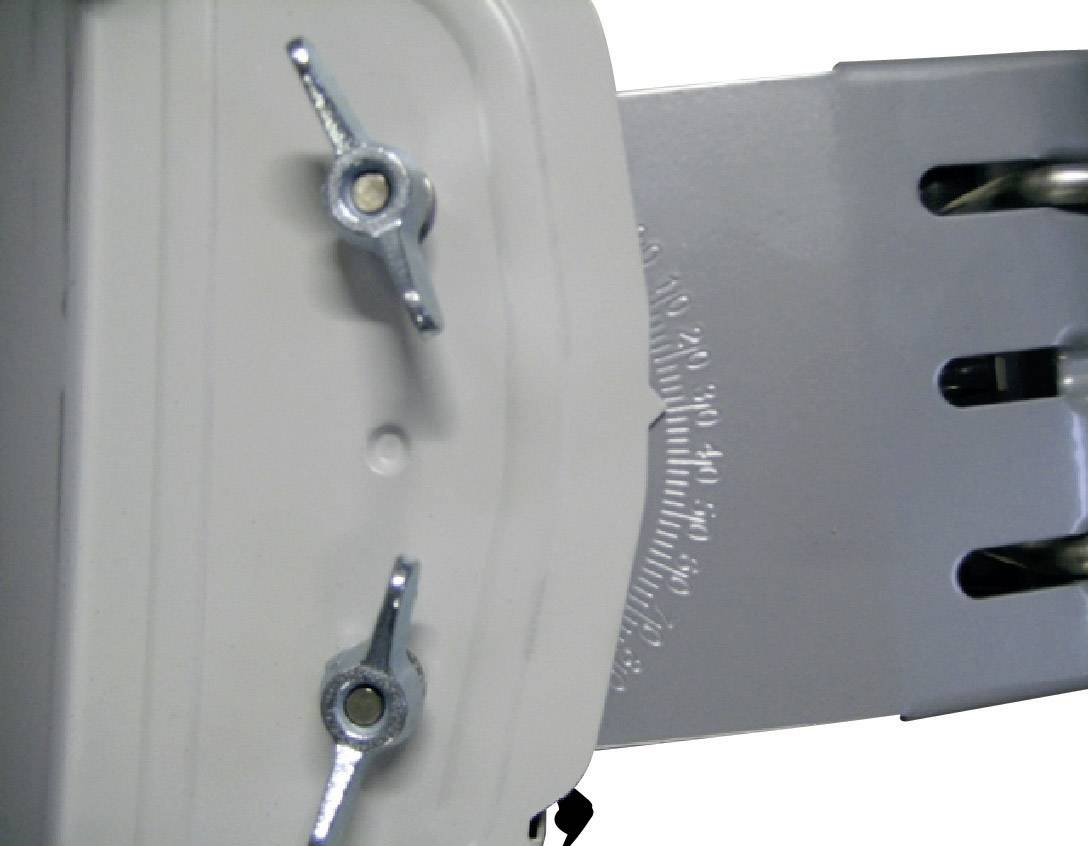 Close-up of a hinge with scale and wing nuts for adjustment.