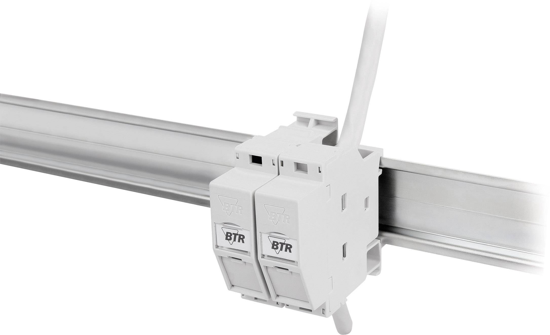 A white cable management system is mounted on a metal rail. A cable is being guided through the system.