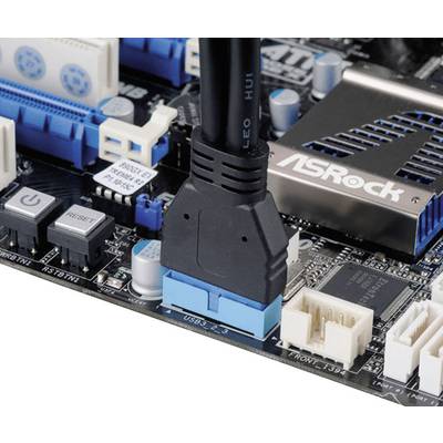 Close-up of a computer motherboard showing an HDMI cable connected. Various ports and switches are visible.