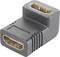 A black HDMI right-angle adapter with two HDMI ports, one on each side, enables connection in confined spaces.