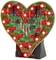 Carte en forme de cœur avec des LED rouges lumineuses, des condensateurs et des résistances. Elle repose sur un socle noir.