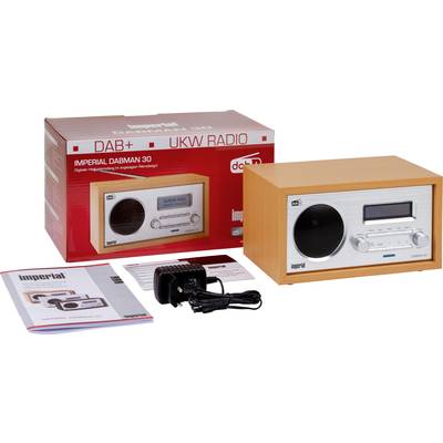 Radio au design rétro avec bouton de réglage du volume et écran, à côté une boîte représentant le même radio, une brochure et un adaptateur secteur.
