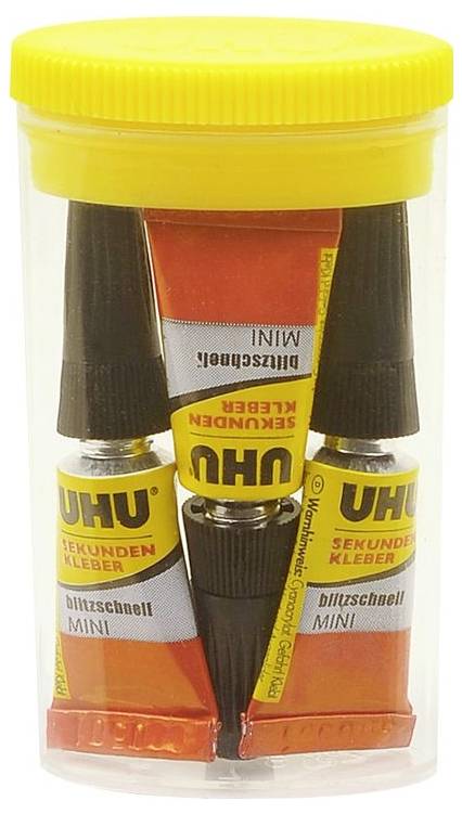 Un bocal jaune contenant plusieurs tubes de colle UHU Instantanée Mini. Les tubes sont rouge et jaune, étiquetés 'ultra-rapide'.