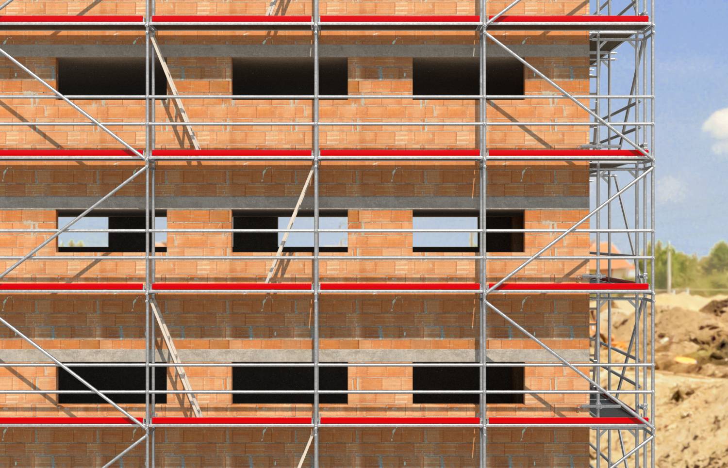 Bâtiment d'appartements en briques partiellement construit avec un échafaudage métallique sur la façade avant sur un chantier de construction.