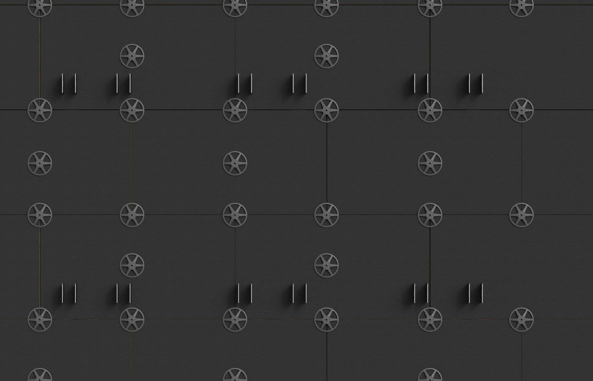 Mur gris foncé avec une grille répétitive d'emblèmes circulaires ressemblant à des roues et de poignées verticales appariées, évoquant des portes de panneau ou d'armoire industrielle.