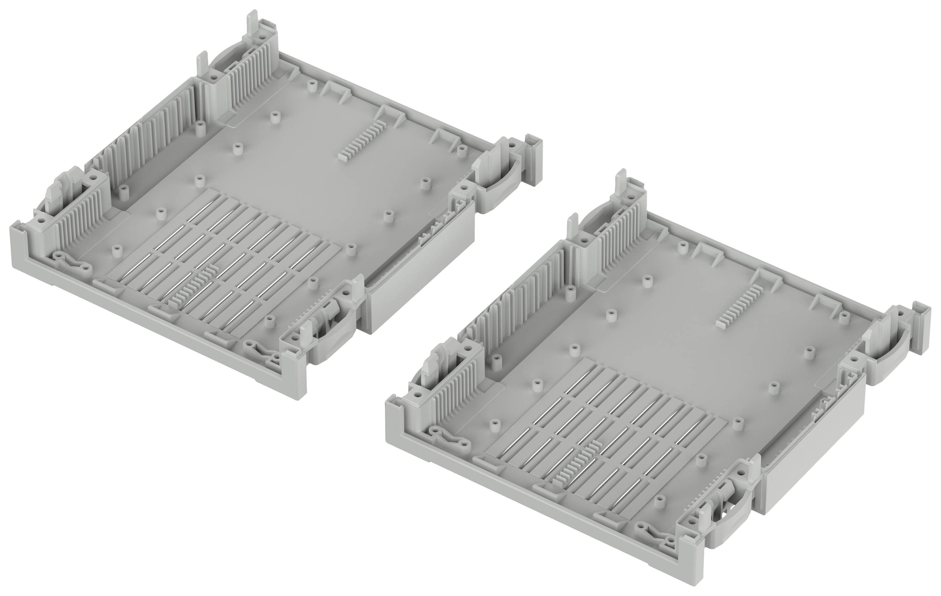 Deux supports en plastique gris placés côte à côte. Ils présentent des bords surélevés et des détails structurels fins, probablement des composants d'un boîtier d'appareil.
