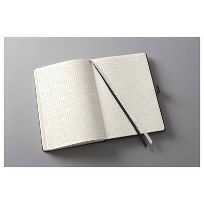 Un carnet de graphique vierge et ouvert avec un signet de ruban noir posé en diagonale sur les pages sur une surface grise.