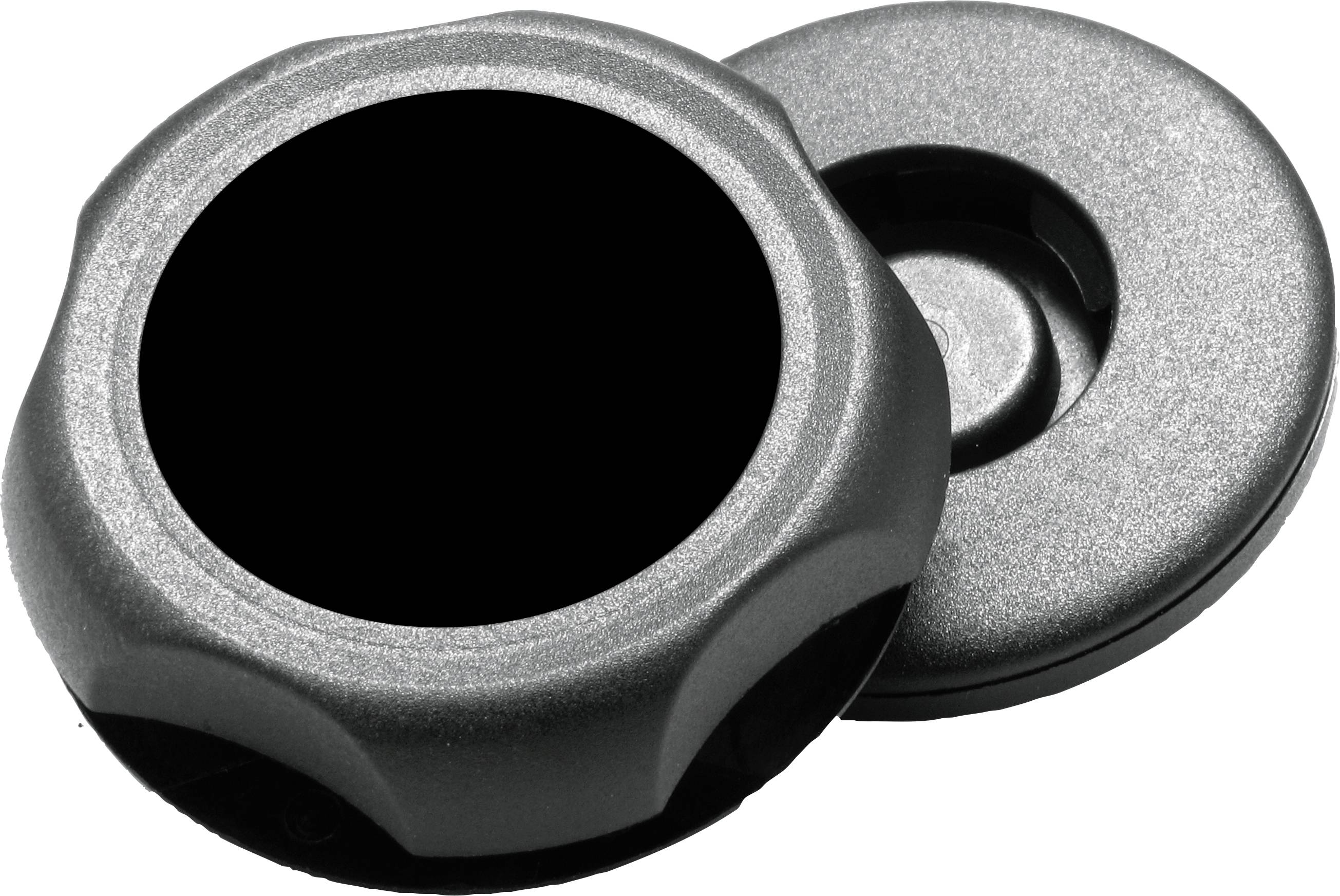 Deux couvercles ronds en argent, l'un dressé avec un centre noir, l'autre posé à plat. Ils semblent être faits de métal et de plastique.