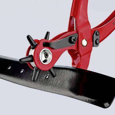 Un outil de perforation en cuir rouge avec une tête rotative, appliqué sur une ceinture en cuir noir.