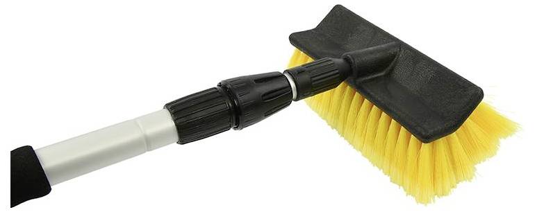 Brosse jaune avec manche noir, adaptée au nettoyage des surfaces.