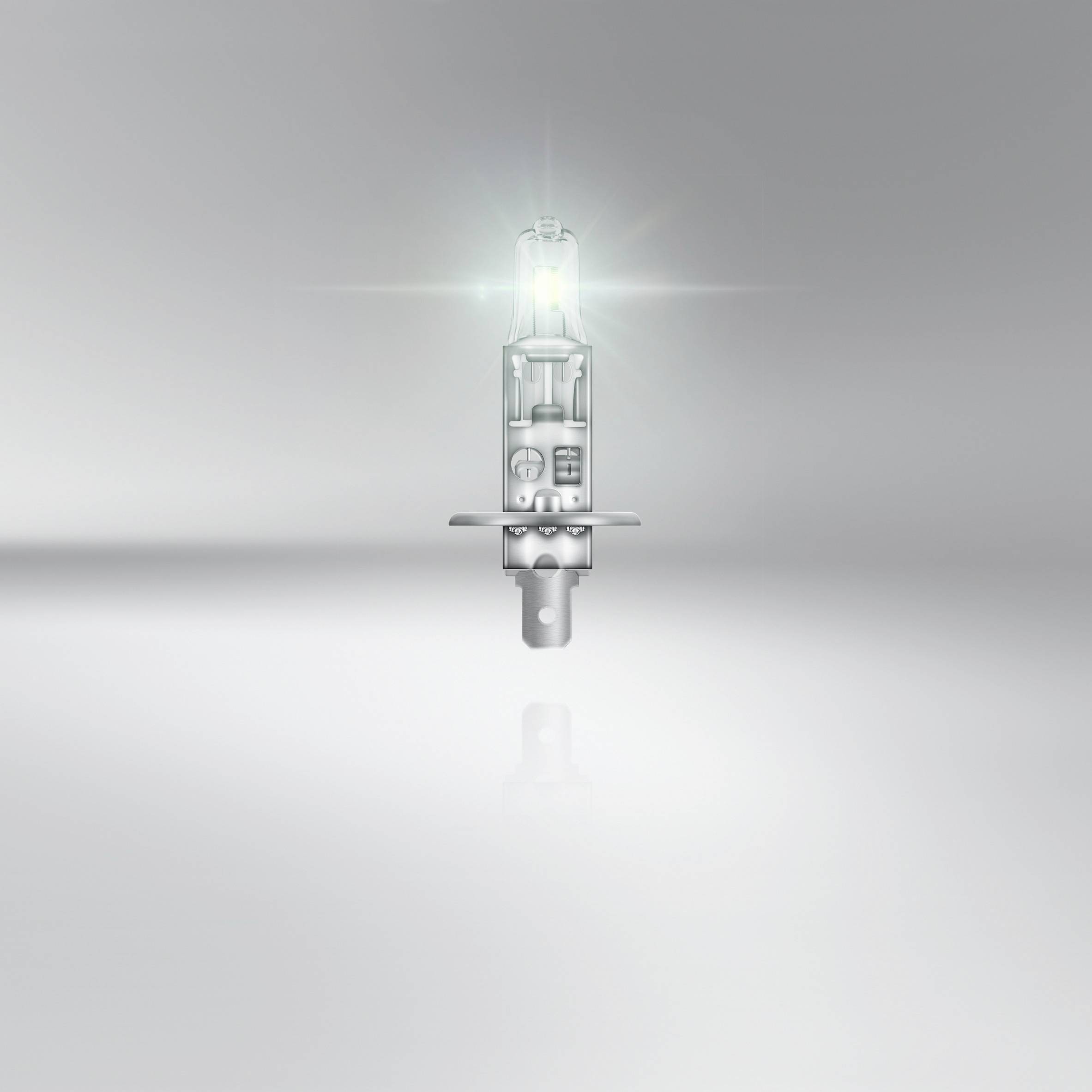 Une lampe halogène lumineuse flotte devant un fond gris, diffusant une lumière vive et symbolisant l'innovation et l'illumination.