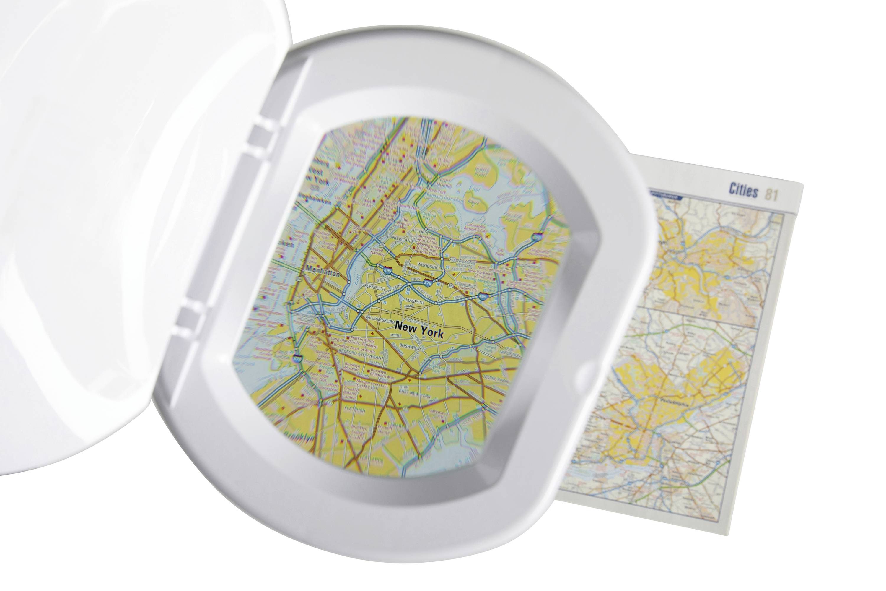 Une loupe circulaire montre un plan détaillé de New York, entourée d'un dépliant comprenant plusieurs sections cartographiques.