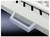 Un tiroir gris avec une poignée argentée. En haut, une partie d'un clavier blanc est visible.