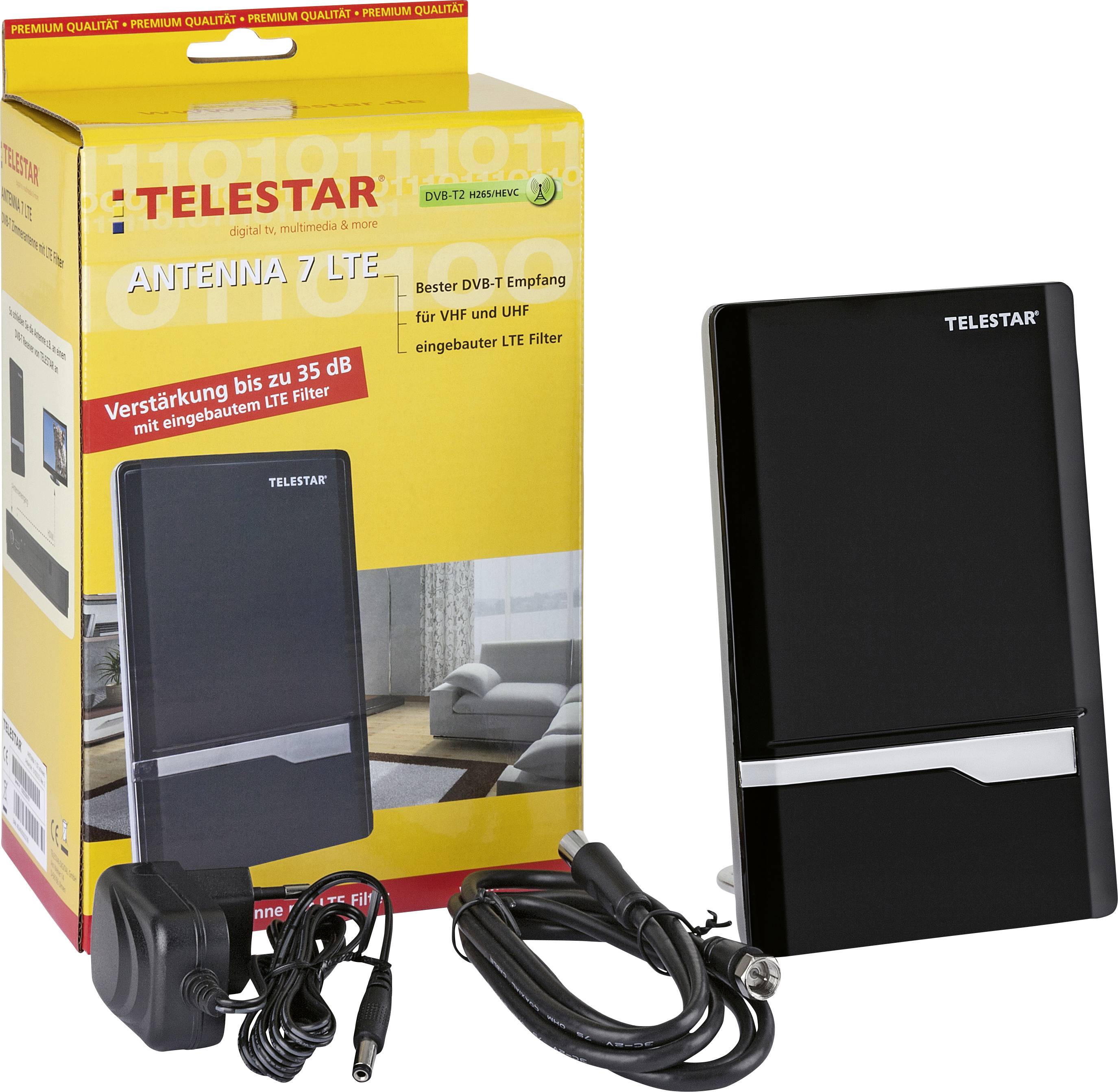 Une antenne TV noire rectangulaire 'TELESTAR Antenna 7 LTE' à côté d'un emballage jaune contenant un câble et un adaptateur secteur.