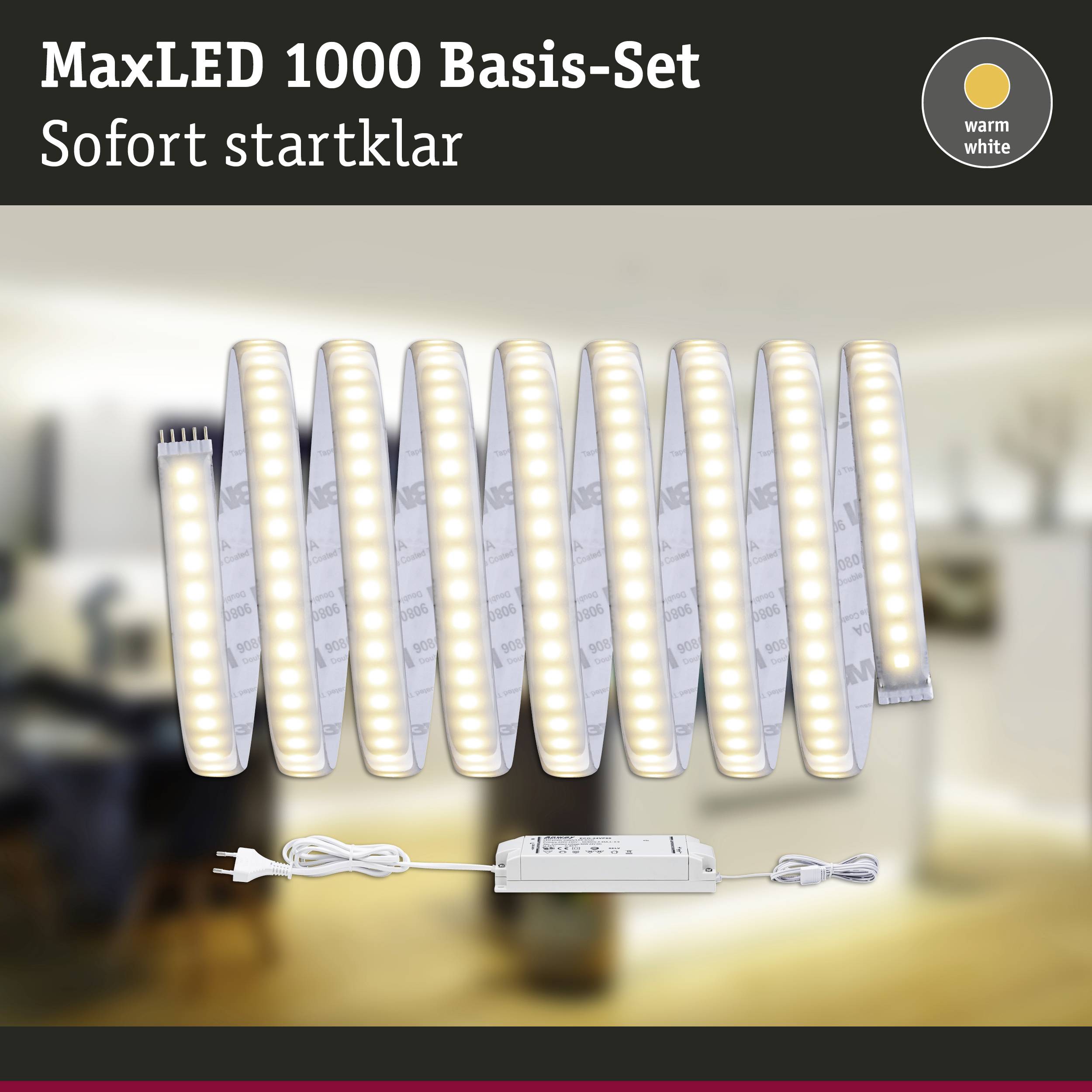 Ensemble de base MaxLED 1000, bande lumineuse LED, blanc chaud, avec bloc d'alimentation. Arrière-plan montrant un salon flou. Texte : 'Prêt immédiatement'.