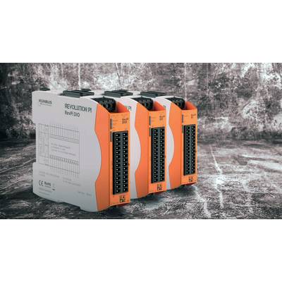 Quatre modules industriels orange et blanc de KUNBUS portant l'inscription 'Revolution PI RevPi DIO', posés sur une surface grise structurée.