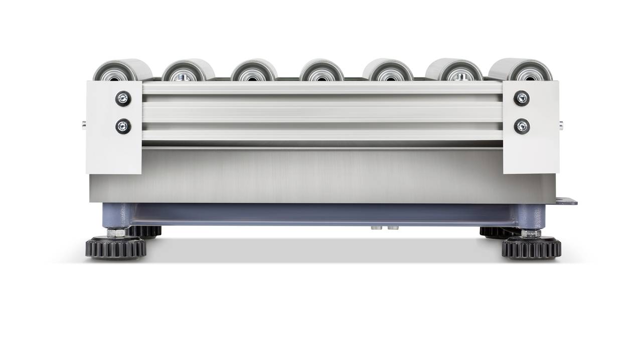 Un dispositif mécanique doté de plusieurs rouleaux repose horizontalement sur une base plane. La structure paraît industrielle et robuste.