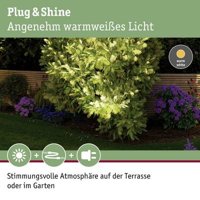 Lampe Plug & Shine avec lumière blanc chaud dans un environnement de jardin, idéale pour une terrasse à l'ambiance feutrée ou un éclairage de jardin.