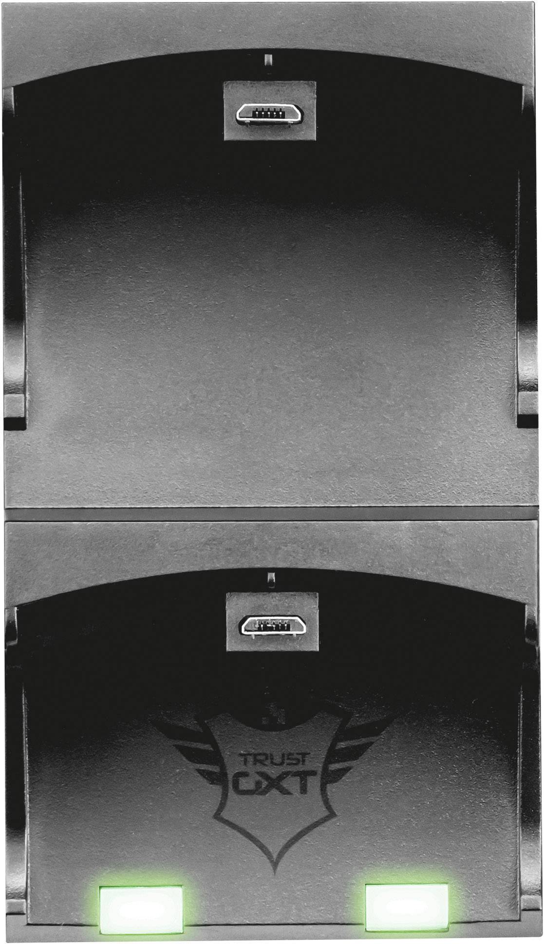 Station de charge double pour deux manettes. Emplacements supérieurs avec ports USB. Deux voyants verts en bas indiquent que l'appareil est prêt à fonctionner.