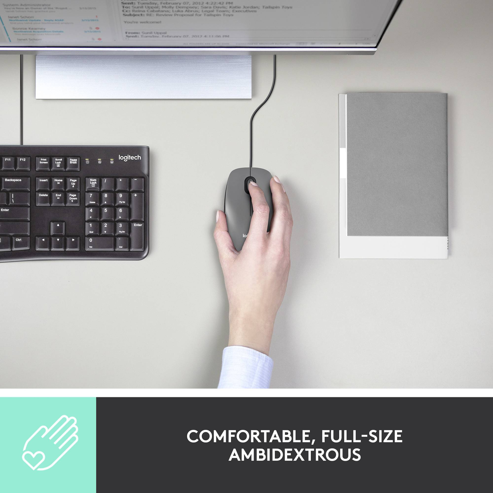 Une main utilise une souris d'ordinateur à côté d'un clavier sur un bureau. En dessous est inscrit : 'Confortable, taille standard et ambidextre'.