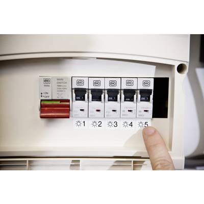 Un doigt pointe vers un boîtier de disjoncteurs électriques avec plusieurs interrupteurs numérotés de 1 à 5. L'interrupteur principal est éteint.