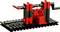 Un modèle LEGO noir et rouge sur un socle, représentant une sorte de dispositif mécanique ou de machine.