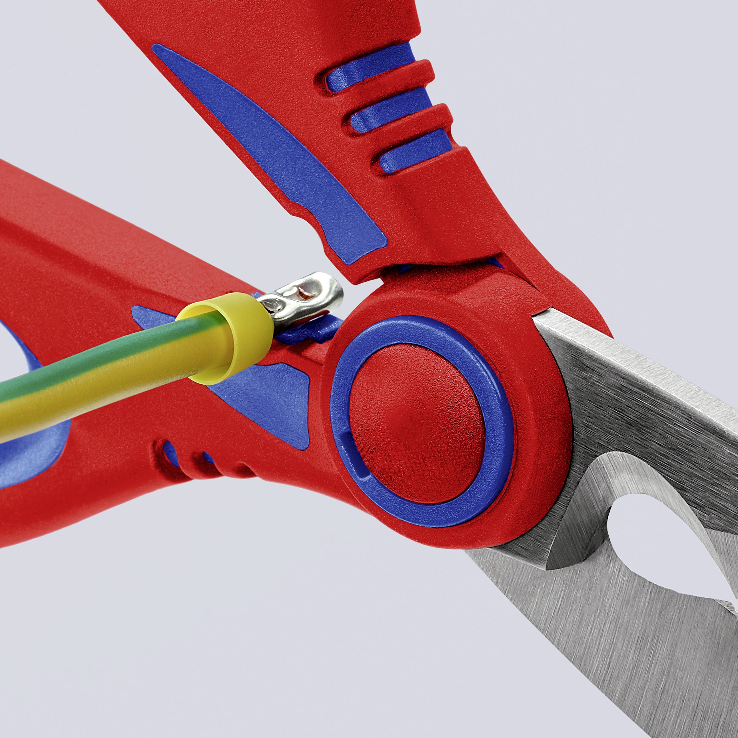 Une pince rouge et bleue coupe un câble jaune et vert.