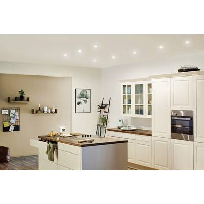 Cuisine lumineuse et moderne avec façade d'armoires blanches, plans de travail en bois, îlot central et éléments décoratifs muraux.