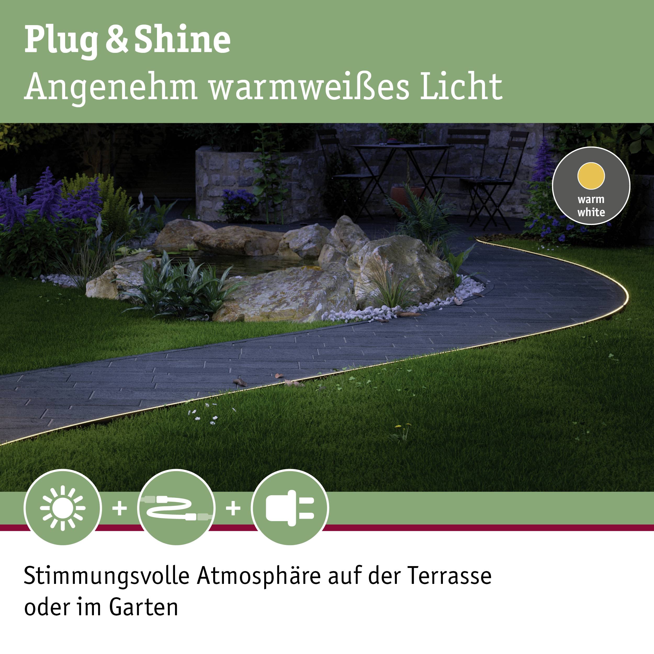 Paysage de jardin nocturne avec éclairage blanc chaud. Texte : 'Plug & Shine. Lumière agréablement blanc chaud.' Parfait pour terrasse ou jardin.