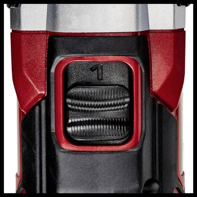 Gros plan d'un interrupteur sur un appareil technique. L'interrupteur présente un réglage portant le numéro '1' et se trouve dans un boîtier avec des détails rouges et noirs.