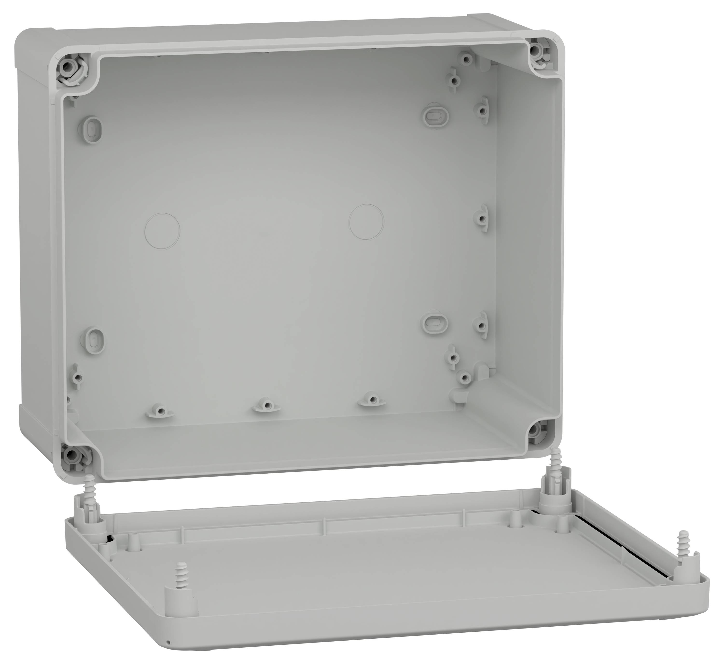Un boîtier électrique gris ouvert et vide, avec des vis de montage visibles, utilisé pour loger des composants électroniques.