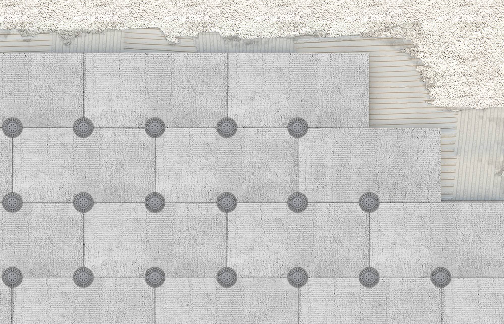 Vue de dessus d'une disposition de dalle de béton gris avec des points d'ancrage circulaires et des lignes de connexion, montrant une zone de fondation inachevée ou planifiée.