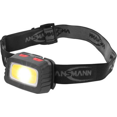 Une lampe frontale noire avec une lumière jaune brillante à l'avant et une bande réglable portant l'inscription 'ANSMANN'.