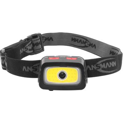 Lampe frontale avec bandeau noir, deux boutons rouges en haut et une source lumineuse centrale à LED.