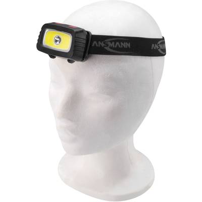 Lampe frontale sur une tête de mannequin. Bandeau noir avec éclairage LED jaune. Adaptée aux activités de plein air dans l'obscurité.