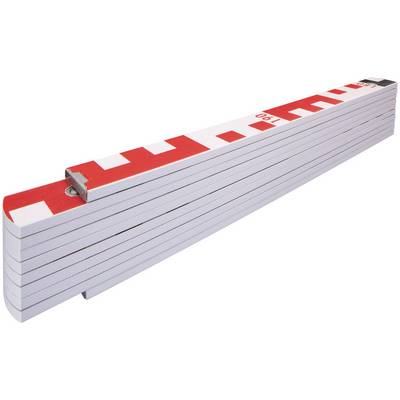 Un mètre pliant blanc replié avec des marquages rouges est posé en diagonale dans l'image.