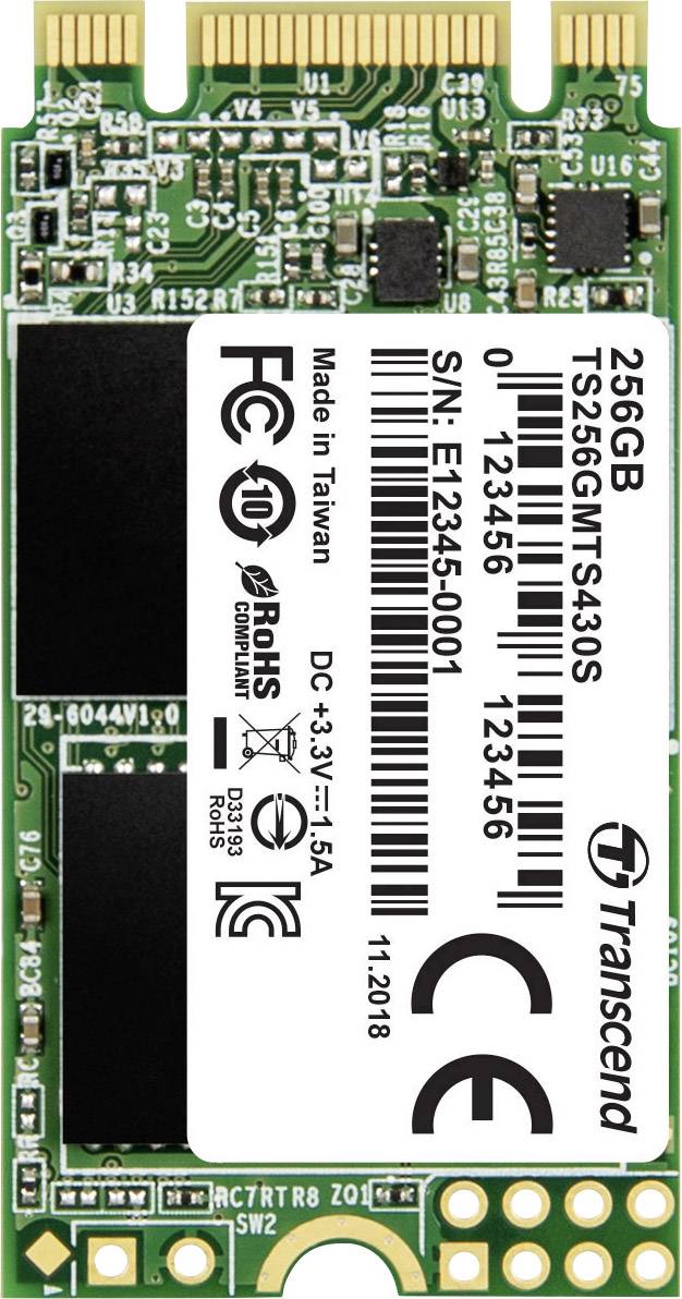 Une SSD Transcend verte de 256 Go au format M.2 avec des informations techniques et des symboles d'homologation sur l'étiquette.