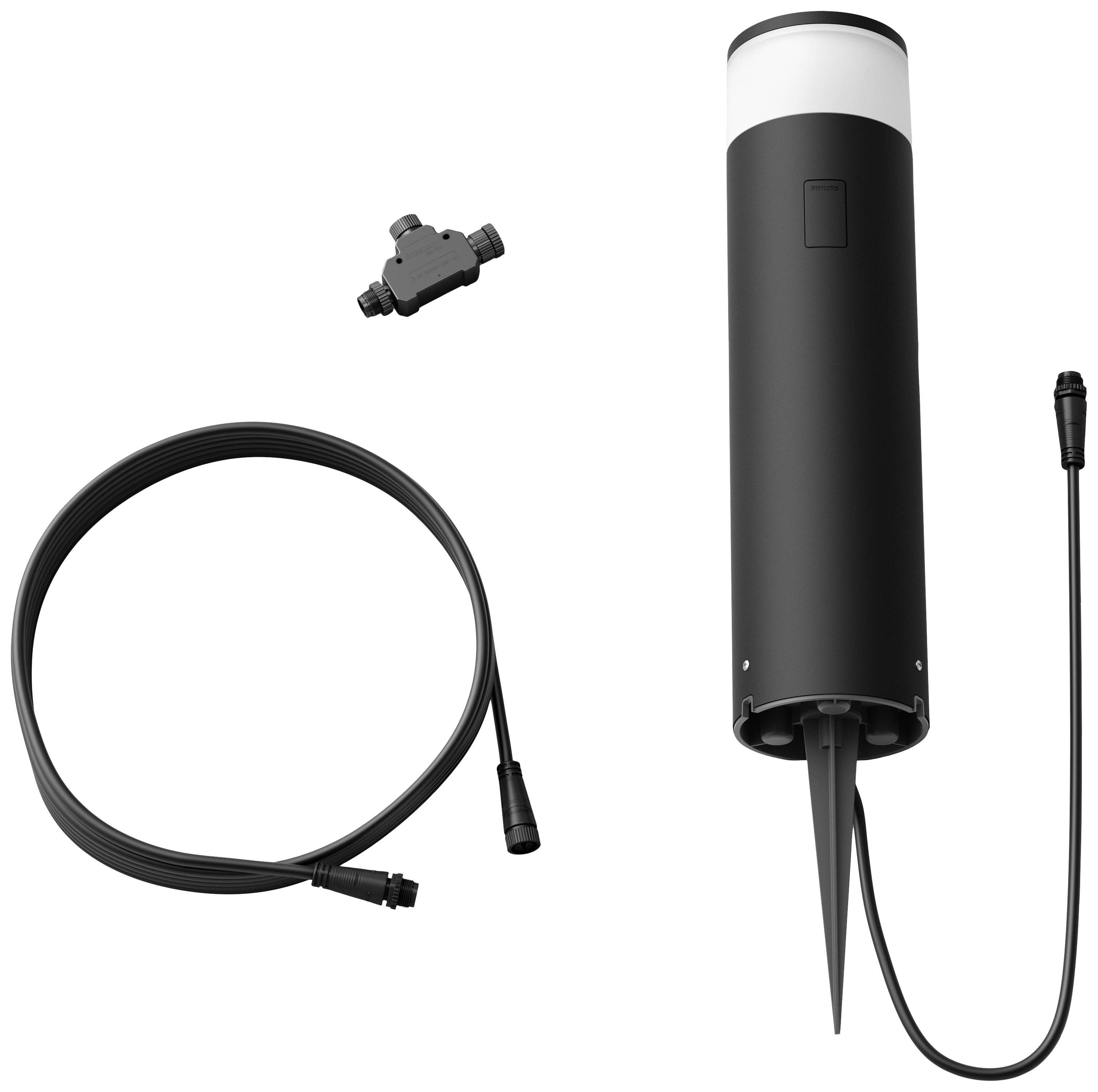 Un luminaire cylindrique noir avec piquet de terre, câble et connecteur est étalé sur un fond blanc.