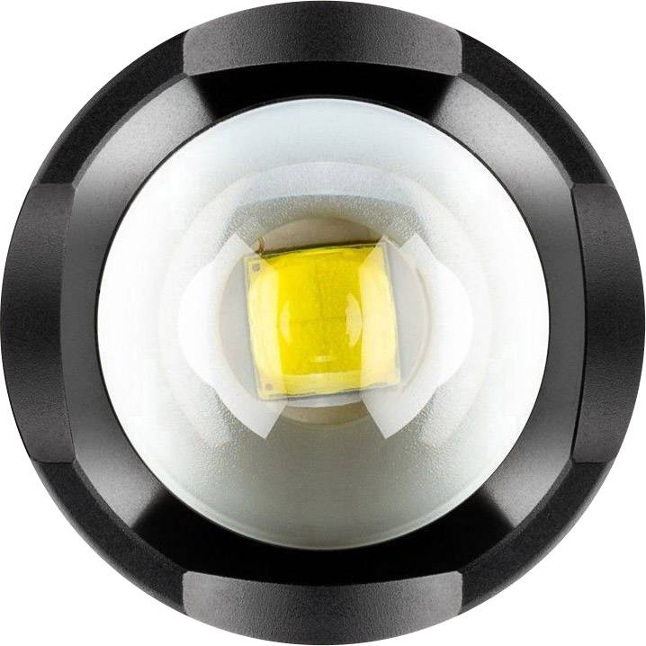 Un gros plan d'une lampe LED avec une lentille circulaire et un élément lumineux jaune au centre, vu de dessus.