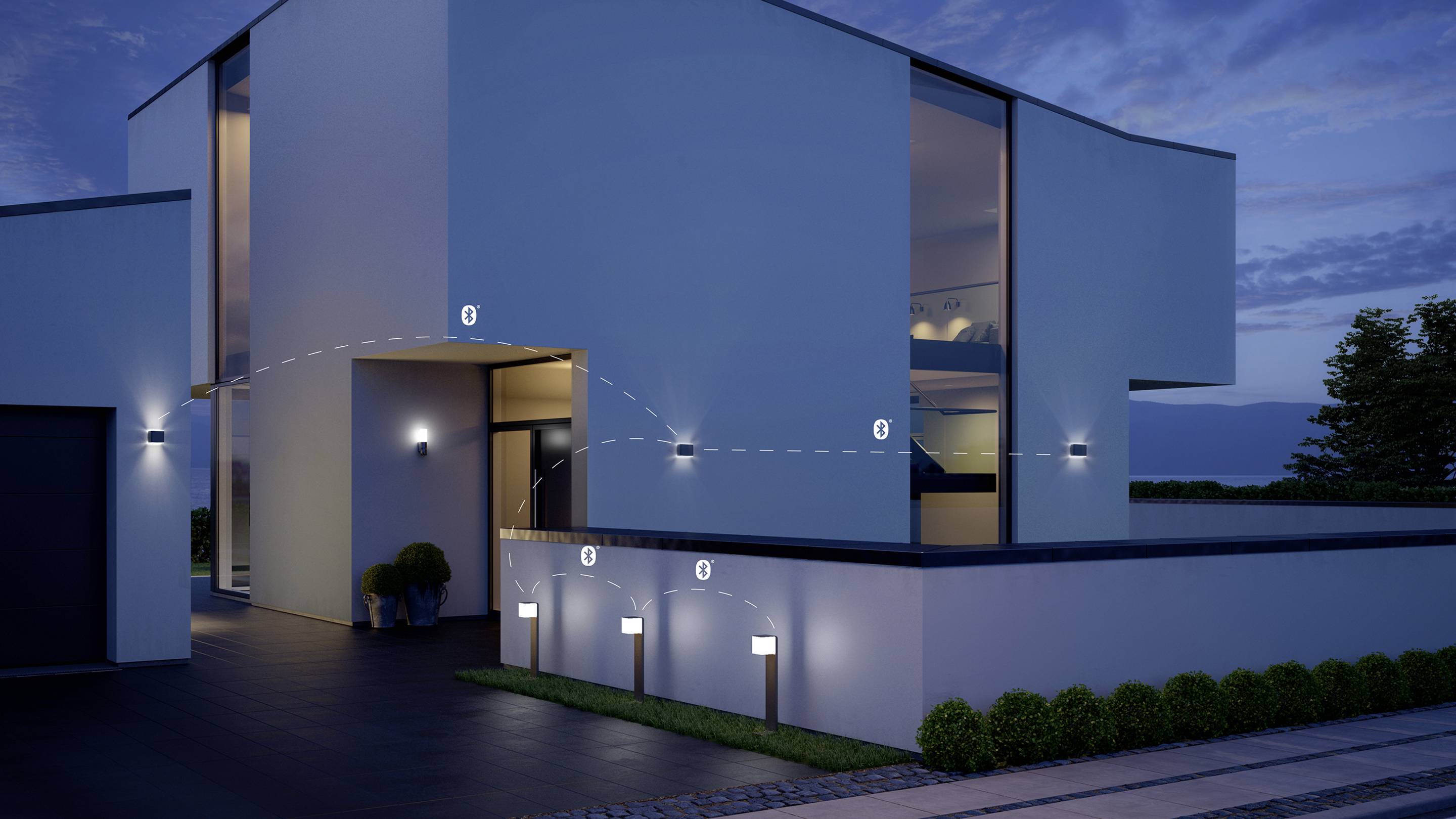 Maison moderne au crépuscule avec façade éclairée et lumières numérotées formant un chemin lumineux le long de l'allée.