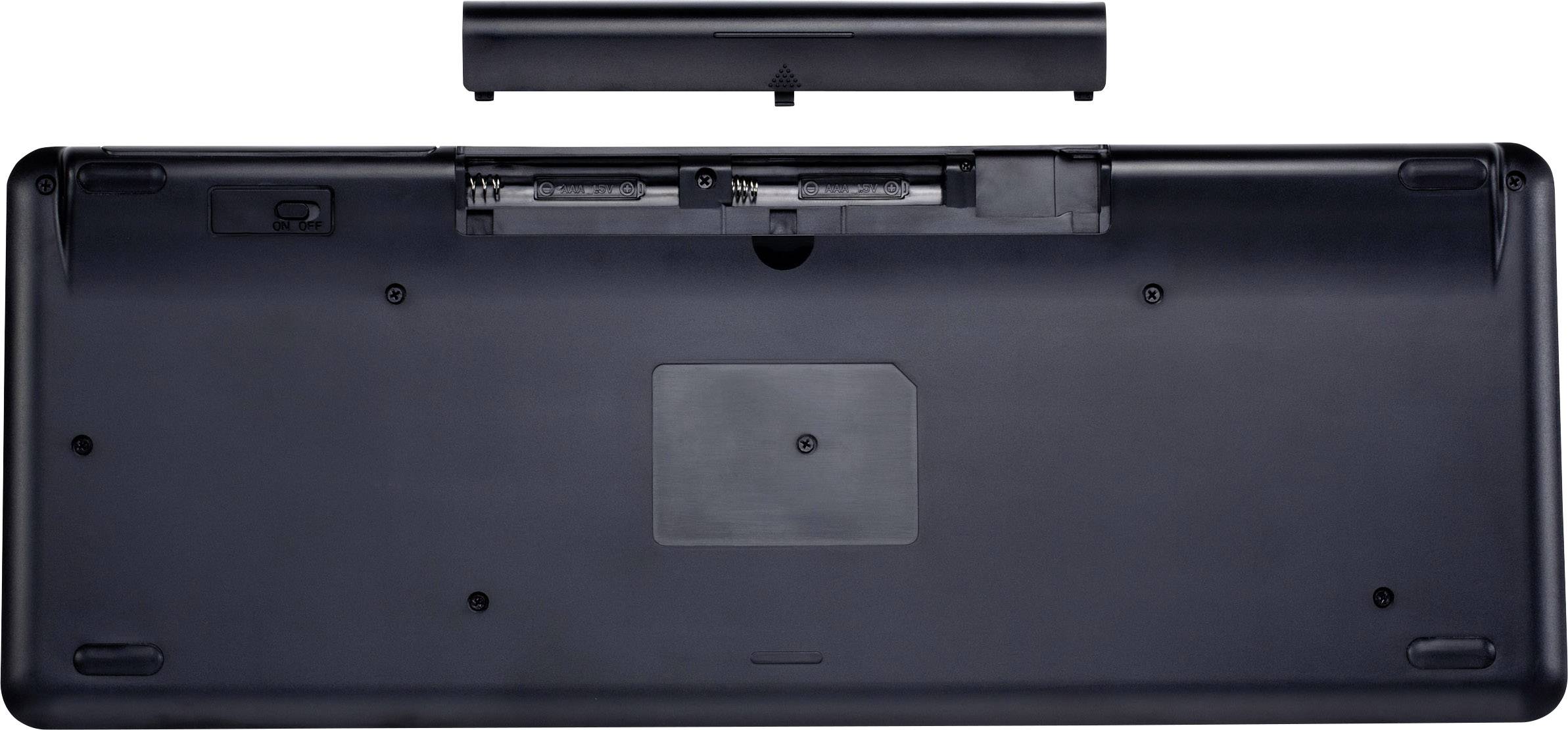 Vue du dessous d'un ordinateur portable avec une batterie amovible. L'ordinateur portable est ouvert, montrant le compartiment de batterie vide et les différents ports de connexion.