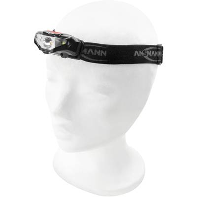 Un lampon frontal noir avec un bandeau élastique sur un modèle de tête blanc.